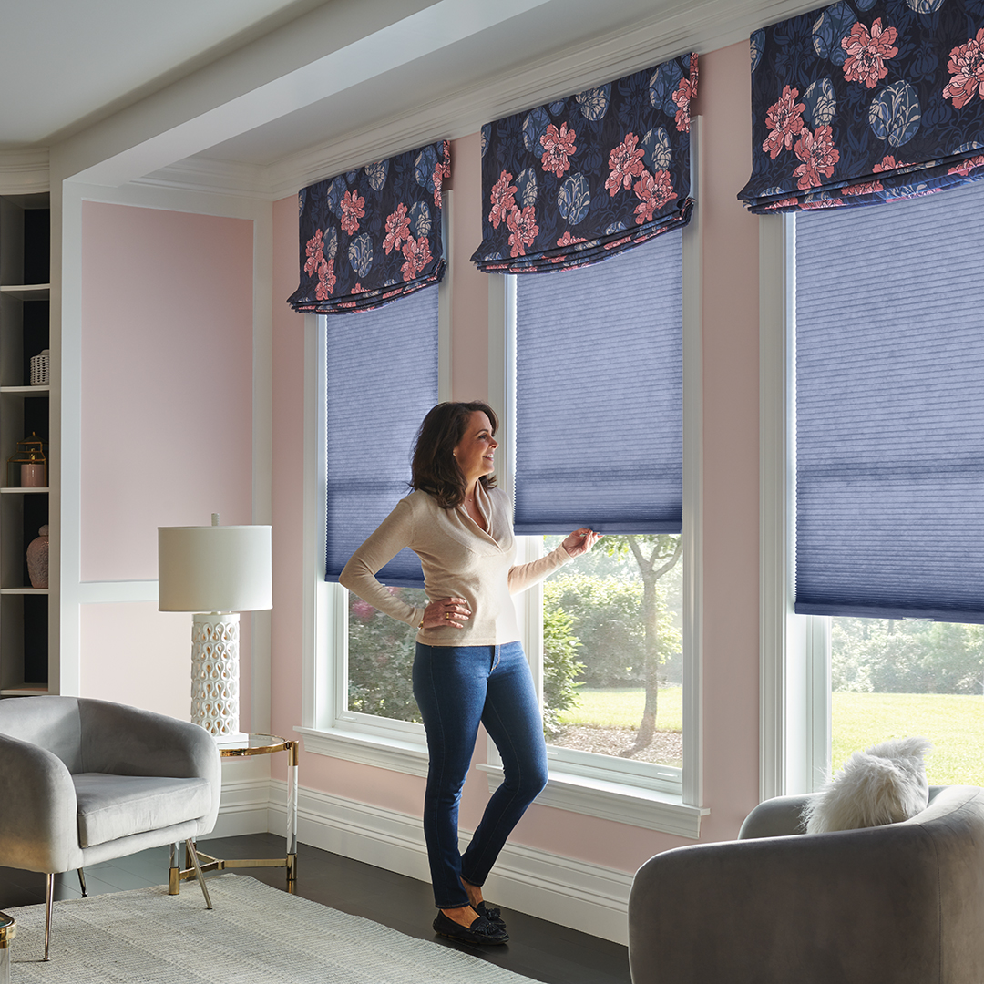 Cellular Shades and Valance in Bedroom with Woman Pulling DownShade